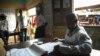 A polling officer looks through a list of voters during presidential election in Conakry, Guinea on October 11, 2015. (Photo: C. Stein)