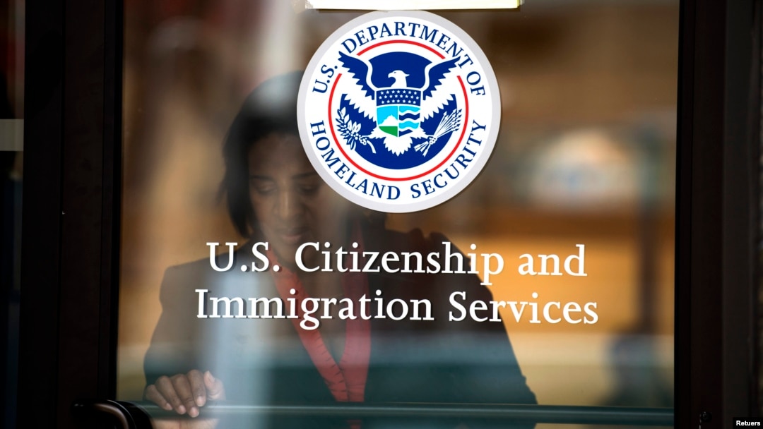 FILE - A woman leaves the U.S. Citizenship and Immigration Services offices in New York.