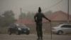 A policeman keeps watch on the road leading to Taraba state electoral commission during the announcement of the results of the Governorship and State assembly elections in Jalingo, Nigeria, April 12, 2015. 