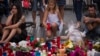 A girl places a candle after a terror attack that killed 14 people and wounded over 120 in Barcelona, Spain, Aug. 20, 2017. (