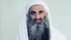 FILE - This February 2017 photo provided by his lawyers shows Khalid Sheikh Mohammed in Guantanamo Bay prison in Cuba. Mohammed, accused of being the mastermind behind the 9/11 attacks, wants to plead guilty to 2,976 counts of murder to avoid the death penalty.