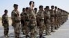 FILE - French troops stand at attention during a handover ceremony of the Timbuktu mission to Burkina Faso at Timbuktu airport on April 23, 2013. 