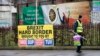 A man walks past republican posters referring to Brexit in West Belfast, Northern Ireland, Feb. 28, 2017. 