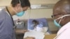 A doctor (left) and a nurse discuss the condition of a patient infected with both HIV and tuberculosis in a hospital in South Africa 