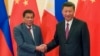 FILE - Philippine President Rodrigo Duterte, left, and Chinese President Xi Jinping pose for photographers on the sidelines of the Belt and Road Forum for International Cooperation at the Great Hall of the People in Beijing, May 15, 2017. 