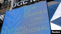 The official logo with a Palme d'Or symbol is seen on a screen in front of a cinema before the presentation of the official selection of the 74th Cannes International Film Festival in Paris, France, June 3, 2021.