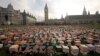 Thousands of personalized cardboard characters are pictured outside Britain's Houses of Parliament in central London, on March 4, 2013, during a photocall organized by Fairtrade Foundation, calling on British Prime Minister David Cameron to put smallholde