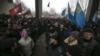 Ukrainian police separate ethnic Russians (L) and Crimean Tatars during rallies near the Crimean parliament building in Simferopol, Feb. 26, 2014.