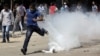 An Egyptian protester runs away from a tear gas canister fired by riot police, near street leading to U.S. embassy during clashes in Cairo, September 14, 2012.