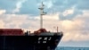 FILE - The Chinese bulk carrier Yi Peng 3 is anchored and being monitored by a Danish naval patrol vessel (unseen) in the sea of Kattegat, near the City og Granaa in Jutland, Denmark, on Nov. 20, 2024.