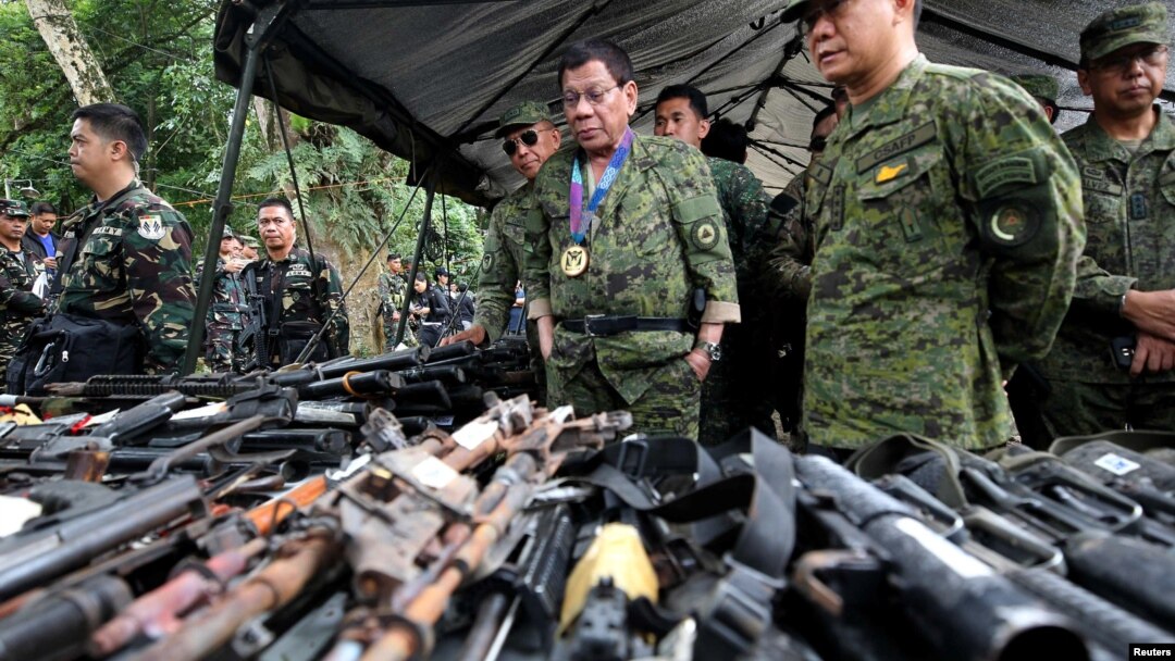 Philippine President Rodrigo Duterte inspects firearms together with Eduardo Ano, Chief of Staff of the Armed Forces of the Philippines (AFP), during his visit at the military camp in Marawi city, southern Philippines, July 20, 2017.