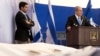 Israel's PM Benjamin Netanyahu (R) delivers a speech near the covered bodies of victims of Friday's attack on a Paris grocery, during their joint funeral in Jerusalem, Jan. 13, 2015. 