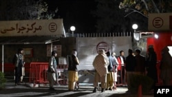 Relatives of blast victims gather outside the Italian aid organization emergency hospital in Kabul on Nov. 7, 2023, following an explosion on a bus.