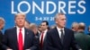 U.S. President Donald Trump and NATO Secretary General Jens Stoltenberg wait to take their seats prior to a NATO leaders meeting at The Grove hotel and resort in Watford, Hertfordshire, England, Dec. 4, 2019. 