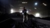 FILE - A laborer works inside a coal yard on the outskirts of Ahmedabad, India, April 6, 2017.