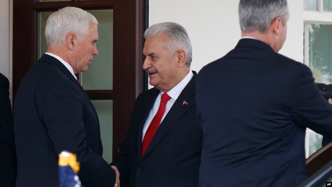 Vice President Mike Pence, left, shakes hands with Turkish Prime Minister Binali Yildirim after a meeting at the White House, Nov. 9, 2017, in Washington.