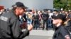 People stand outside during a visit of German Chancellor Angela Merkel to an asylum seekers accomodation facility in the eastern German town of Heidenau near Dresden, August 26, 2015 where last week more than 30 police were injured in clashes, when a mob 