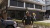 Pakistani police officer stands guard at the office of Axact software company in Karachi, May 27, 2015.