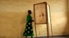 FILE - A woman walking towards a voting booth in Bujumbura, Burundi, as people prepared to vote in a presidential election, June 28, 2010.