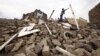 A youth throws a plank of wood away from a pile of rubble of a house destroyed during an airstrike carried out by the Saudi-led coalition in Faj Attan village, Sanaa, Yemen, May 7, 2015. 