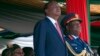 Kenyan president Uhuru Kenyatta, centre, Commander-in-Chief of the Armed Forces, left, stands with Gen Julius Waweru Karangi, right, Chief of the Defence Forces, as they watch the passing out parade and fly over by the Kenyan Air Force, Oct. 20, 2013.