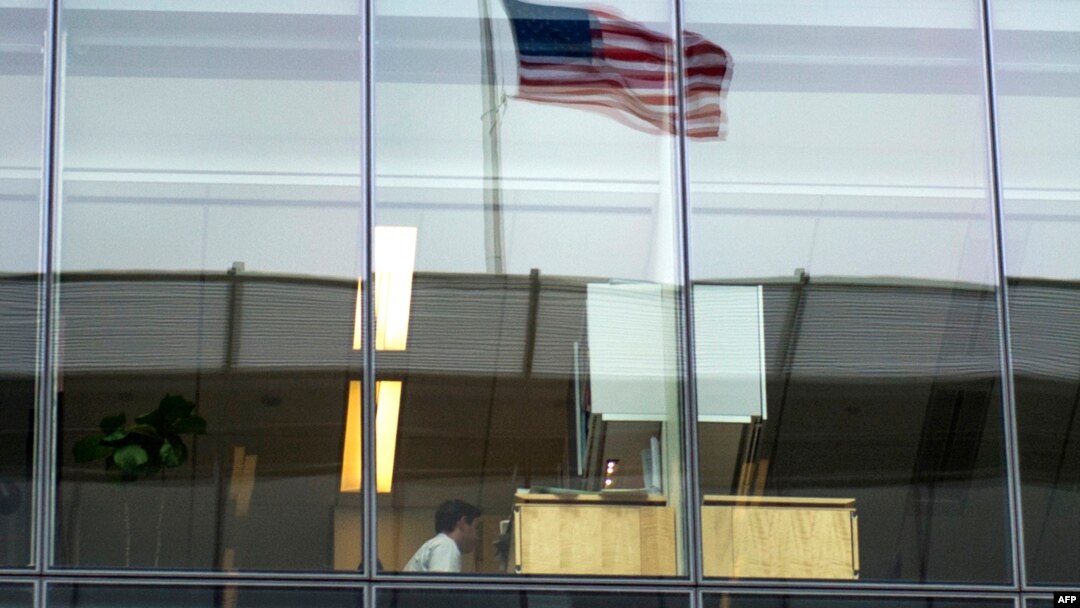 FILE - An office worker sits at his desk at a bank in Washington, D.C., May 5, 2016.