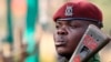 A Kenya General Service Unit policeman stands guard in the area around Westgate shopping mall in Nairobi, Sept. 25, 2013.