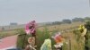 A supporter of African far-right leader Euguene Terre'Blanche looks at flowers and pays tribute in front of the entrance of the farm in Ventersdorp, 05 Apr 2010