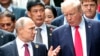 FILE - U.S. President Donald Trump and Russia's President Vladimir Putin talk during the family photo session at the APEC Summit in Danang, Vietnam, Nov. 11, 2017. 