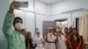 Health workers celebrate India administering 1 billion doses of COVID-19 vaccine, at Rajawadi hospital in Mumbai, India, Oct. 21, 2021.