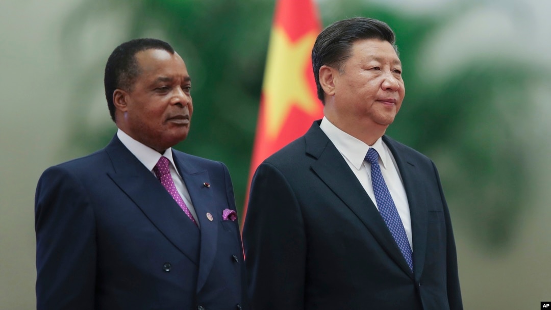 Chinese President Xi Jinping, right, and Congo President Denis Sassou Nguesso listen to their national anthems during a welcoming ceremony inside the Great Hall of the People in Beijing, Sept. 5, 2018.