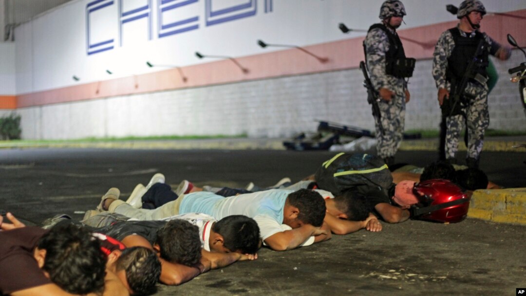 Suspects are detained by police after a store was ransacked by a crowd in the port of Veracruz, Mexico, Jan. 4, 2017. Protests over a sharp gasoline price hike erupted into looting of gas stations and stores in various parts of Mexico.
