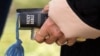 A woman holds a Bible at an open air Sunday church service 