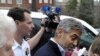 Actor George Clooney, center, and Rep. Jim Moran, D-Va., left, are led to a police vehicle after being arrested during a protest at the Sudan Embassy in Washington, March 16, 2012. 
