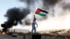 Palestinians remove debris from a building that was damaged in an Israeli strike, in Gaza City, Nov. 19, 2012. 