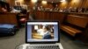 Oscar Pistorius is viewed on a laptop as he sits in the dock in court in Pretoria, South Africa, March 14, 2014.