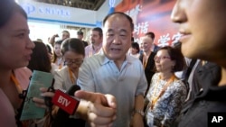 FILE - Literature Nobel Prize winner Mo Yan attends a book fair in Beijing on Aug. 23, 2017. Mo, one of China's most celebrated authors, has been sued and accused of violating the Heroes and Martyrs Protection Law.