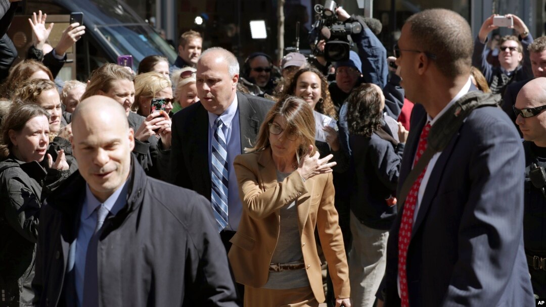 Fans photograph actress Lori Loughlin as she arrives at federal court in Boston, April 3, 2019, to face charges in a nationwide college admissions bribery scandal.