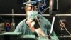 A researcher observes a rat walking on its hind legs during an experiment involving spinal cord injuries, at the Center for Neuroprosthetics and Brain Mind Institute in Ecublens, Switzerland, May 31, 2012.
