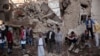 FILE - People gather at the site of a Saudi-led airstrike near Yemen's Defense Ministry complex in Sanaa, Yemen, Nov. 11, 2017. 
