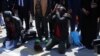 Somali migrants kneel and pray after arriving back in the Somali capital, Mogadishu, Feb. 17, 2018. (Somali Ministry of Information)