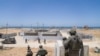 In this picture released by the Israeli army on May 16, 2024, Israeli troops work to connect a U.S.-built floating pier to the shore. The new entry point will allow more humanitarian aid to enter the Gaza Strip.