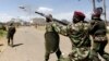 FILE - A riot policeman fires a teargas canister to disperse demonstrators during protests in Narok, Kenya, January 26, 2015.