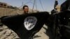 A member of Iraqi Counter Terrorism Service holds an Islamic State militants as he celebrates in the Old City of Mosul, Iraq July 9, 2017. 