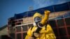 FILE - A health worker stands in the Sambadrome as he sprays insecticide to combat the Aedes aegypti mosquitoes that transmit the Zika virus, in Rio de Janeiro, Brazil, Jan. 26, 2016.