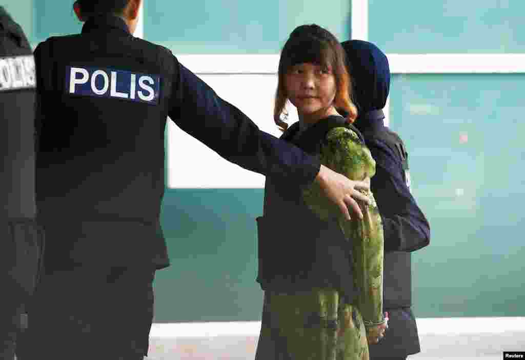 Vietnamese Doan Thi Huong who is on trial for the killing of Kim Jong Nam, the estranged half-brother of North Korea's leader, is escorted as she arrives at the Department of Chemistry in Petaling Jaya, near Kuala Lumpur, Malaysia.