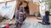 FILE - A woman and her children displaced by fighting in South Sudan sit outside her tent at the Kule camp for Internally Displaced People at the Pagak border crossing in Gambella, Ethiopia, July 10, 2014.
