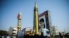 FILE - A display featuring missiles and a portrait of Iran's Supreme Leader Ayatollah Ali Khamenei is seen at Baharestan Square in Tehran, Iran, Sept. 27, 2017.