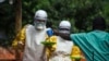 FILE - Medical staff working with Medecins Sans Frontieres (Doctors Without Borders) deliver food to the isolation area of an Ebola treatment center in Sierra Leone's Kailahun district, July 20, 2014.