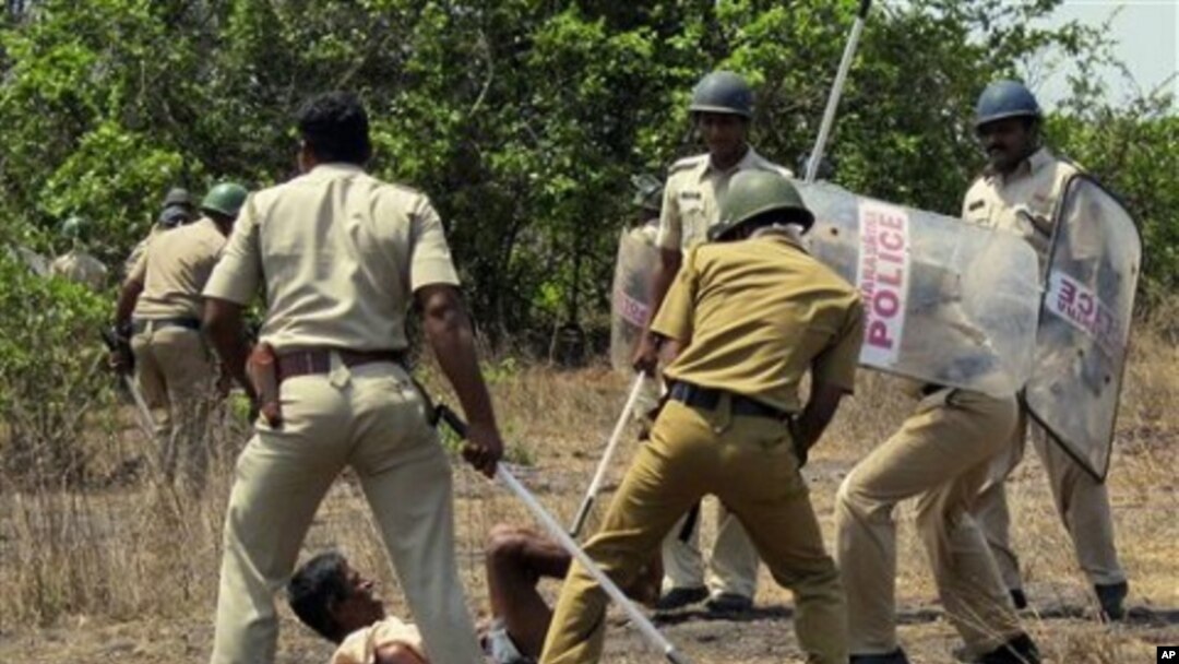 Indian police officers use batons on a villager opposing a government plan to build a nuclear power plant in Jaitapur, Maharashtra state, India, April 19, 2011